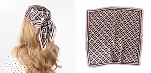 Detail of pink and black geometric satin headscarf shown on model and laid flat
