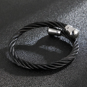 Detail of a black twisted cable punk bracelet with polished silver end caps