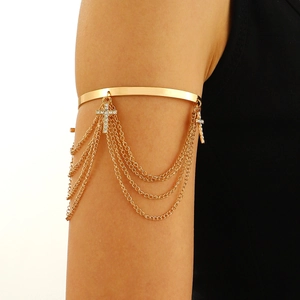 Golden armlet with multi-layer tassel chains and rhinestone cross charms on model
