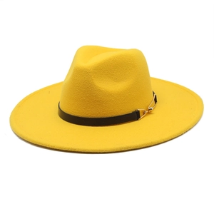 Macro detail of a bright yellow wool fedora hat with black leather band and gold buckle