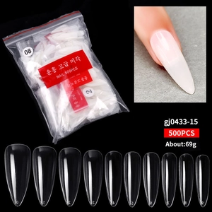 Detailed view of 500-piece stiletto nail tips set in clear and natural colors for manicure