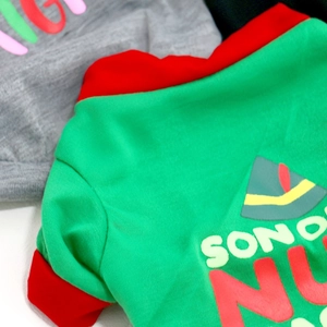 Detail of Christmas elf pet t-shirts with green cotton fabric and red ribbed neckline