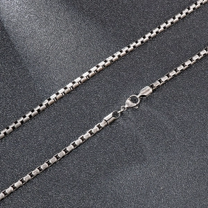 Detailed close-up of a silver square pearl chain with vintage distressed steel texture