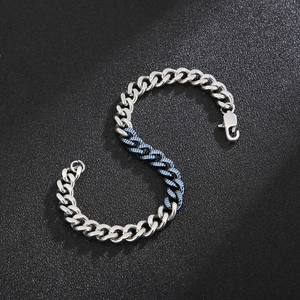 Detail of blue and silver spliced stainless steel Cuban chain bracelet with lobster clasp