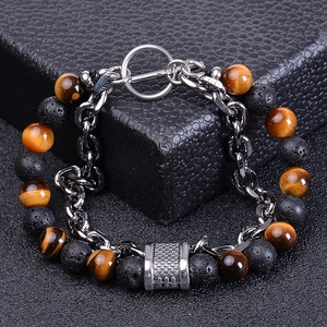 Macro detail of men's double-layer bracelet with tiger eye stones and volcanic lava rock