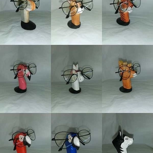 Hand-carved wooden animal eyeglass holders in nine various styles with round bases