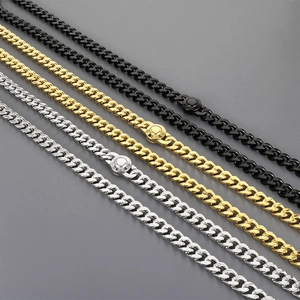 Detail of 11mm Cuban chain necklaces in gold, silver and black with magnetic clasps
