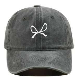 Close-up of white bow embroidery on washed cotton dark grey vintage baseball cap