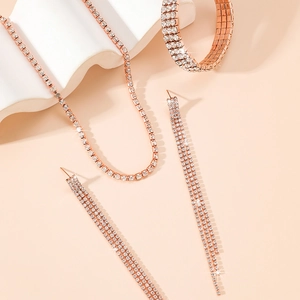 Sparkling rose gold jewelry set with crystal necklace, wide bracelet and fringe earrings