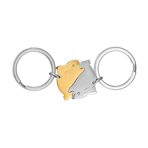 Close-up of interlocking rabbit-shaped metal keychains in gold and silver finish
