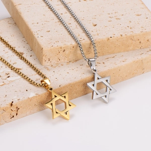 Polished gold and silver stainless steel hexagram star pendant necklaces on stone