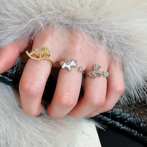 Detailed view of horse-shaped rings with zircon inlay and adjustable silver bands
