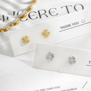 Cross-shaped stud earrings in gold and silver finish with sparkling zircon inlays