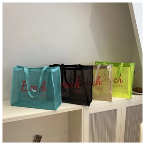 Mesh beach bags in cyan, black, khaki and green colors shown on a white table surface