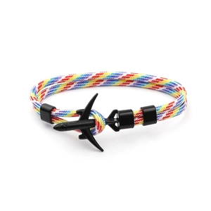 Handmade woven couple bracelet featuring a black airplane charm and colorful paracord rope