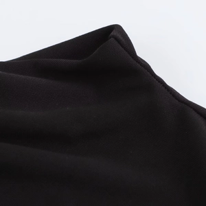 Detailed close-up of high-quality black knit fabric showing fine stitching and texture