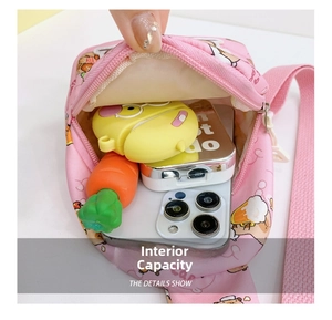 Internal view of pink cartoon crossbody bag showing space for phone and accessories