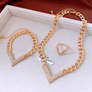 Detailed view of luxury gold link jewelry set with V-shaped rhinestone pavé accents