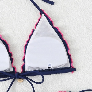 Detail of bikini top with mesh lining, removable pads, and gold metal charm accessory