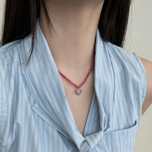 Close-up of S925 silver necklace featuring pink beads and a crystal heart clover pendant