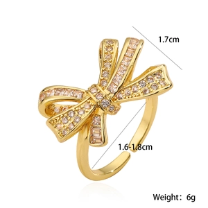 Adjustable gold bow ring with sparkling zircon stones and detailed size measurements