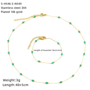 Detail of 18K gold plated stainless steel necklace and bracelet set with green stones