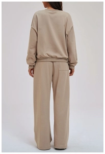 Detail view of the soft cotton fabric and ribbed cuffs on the back of this khaki tracksuit