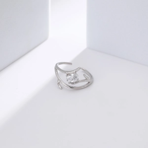 Macro shot of silver tree branch ring with an oval sparkling crystal stone