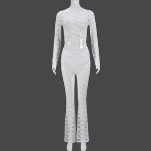 Close-up of white sheer lace fabric texture and floral pattern on two-piece outfit