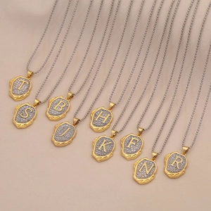 Vintage gold necklaces with irregular initial pendants and silver textured details