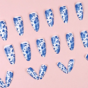 Blue marble ink almond press-on nails with glossy water-ripple pattern on pink backdrop