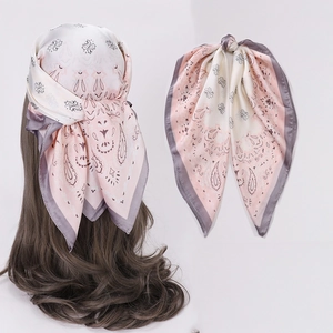 Silk-feel square scarf with paisley print used as a hair tie for long curly hair