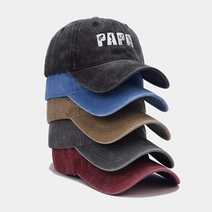 Detail view of five washed cotton sun hats with PAPA embroidery and adjustable straps