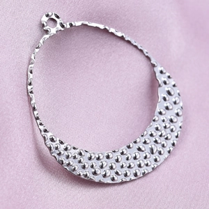 Macro shot of silver hammer-textured crescent pendant in 304 stainless steel