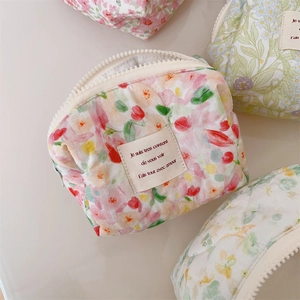 Detailed macro view of quilted floral cotton fabric textures and stitched French label