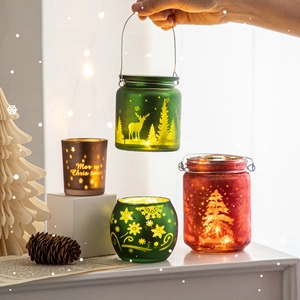 Frosted glass Christmas candle holders with reindeer and snowflake patterns for holiday decor