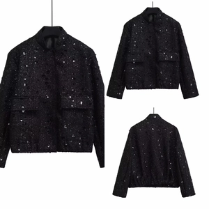 Detail view of black sequin tweed jacket with stand collar and front flap pockets