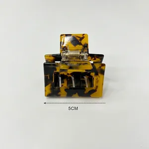 Detailed view of a 5cm tortoise shell hair claw clip with a strong metal spring mechanism