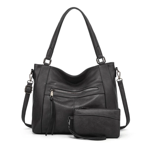 Detail of black large soft leather hobo bag set including a matching smaller pouch and strap