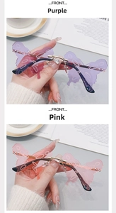 Detail view of purple and pink rimless butterfly sunglasses with wavy wing shaped lenses