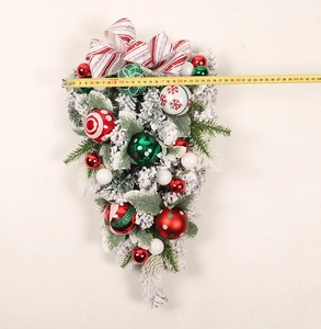 Dimensions of snow-flocked Christmas teardrop swag with colorful ornaments and bow