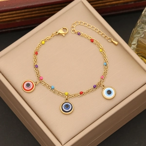 Double-layered gold necklace featuring colorful beads and evil eye charms on a jewelry box