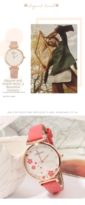 Macro detail of rose gold quartz watch with pink leather strap and cherry blossom dial