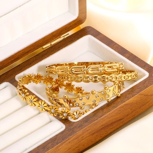 18k gold plated geometric bangle set with sparkling crystals in a jewelry box display