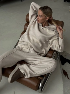 Women's knit lounge set featuring half-zip pullover and wide-leg pants in oatmeal beige