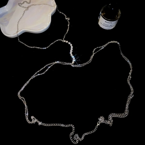 Macro detail of elegant silver rhinestone body chain with shimmering crystal tassels