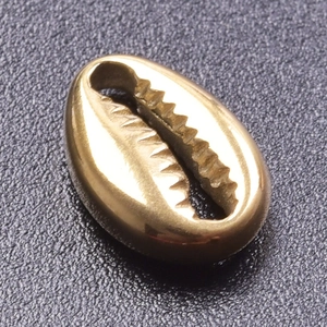 Macro shot of a polished golden seashell bead accessory made of durable stainless steel