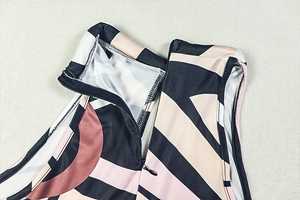 Detail of the high-collar invisible zipper and geometric print on the bodycon jumpsuit