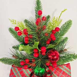 Close-up of Christmas teardrop swag with pine needles, berries and red green plaid bow