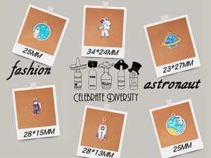 Detail view of colorful space enamel charms including astronaut and rocket with dimensions